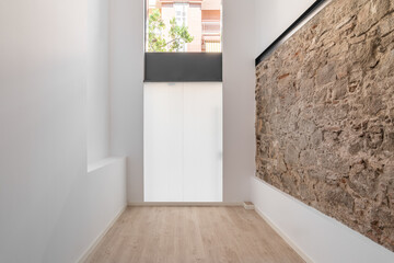 Refurbished apartment with restored ancient wall left from old city buildings.