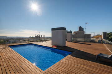 Swimming pool on roof top with clear blue sky on sunny day