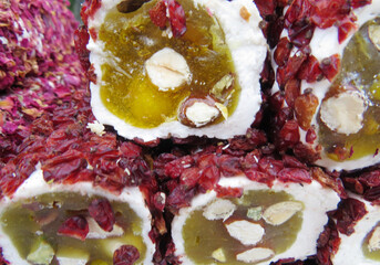 Traditional Turkish delicacies. Varieties of Turkish Delight with Pistachio.Turkish delight sweet cubes background. Lokum sprinkled with sugarin , display at a street food market