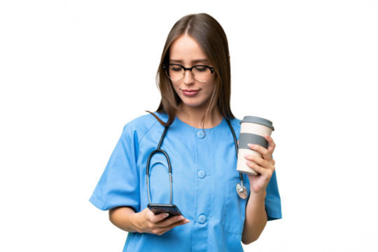 Young nurse caucasian woman over isolated background holding coffee to take away and a mobile