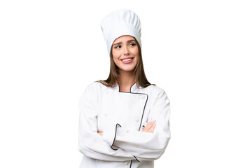 Young chef caucasian woman over isolated background looking up while smiling