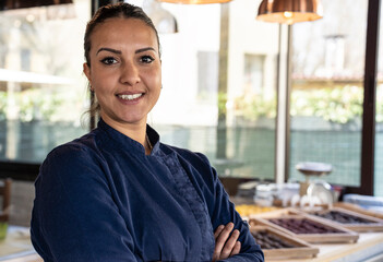 Young north african chef woman smiling on camera at the restaurant - Focus on face - obrazy, fototapety, plakaty