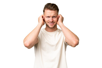 Fototapeta premium Young blonde caucasian man over isolated background frustrated and covering ears