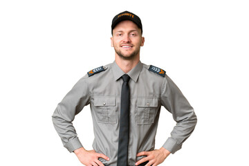 Young security caucasian man over isolated background posing with arms at hip and smiling