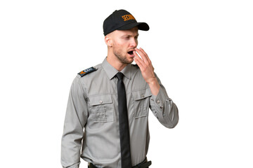 Young security caucasian man over isolated background yawning and covering wide open mouth with hand