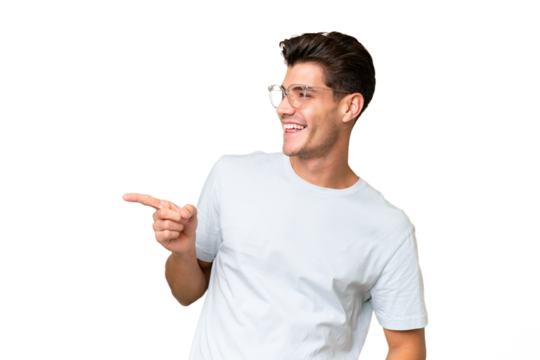 Young caucasian handsome man over isolated background pointing finger to the side and presenting a product