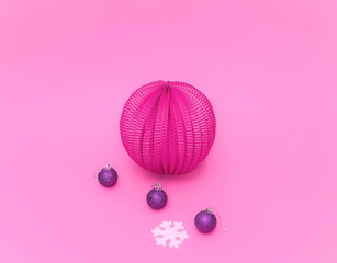 Fototapeta na wymiar Lantern, Christmas tree decoration balls and sbowflake on pink background