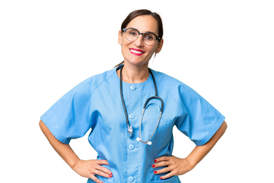 Middle-aged nurse woman over isolated background posing with arms at hip and smiling