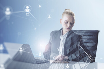 businesswoman sitting on chair and using laptop computer with abstract glowing people and light bulb network on blurry background. Networking, internet communication and social media concept. 