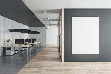 Front view on blank white poster on black wall with space for your logo or text in sunlit eco style office with stylish minimalistic work places and wooden floor. 3D rendering, mockup