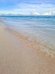 Fototapeta na wymiar Tropical beach in the Derawan. Beautiful sandy beach and soft blue ocean wave