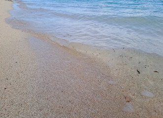Tropical beach in the Derawan. Beautiful sandy beach and soft blue ocean wave