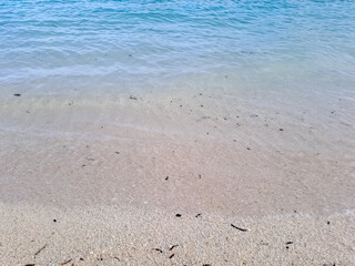 Tropical beach in the Derawan. Beautiful sandy beach and soft blue ocean wave