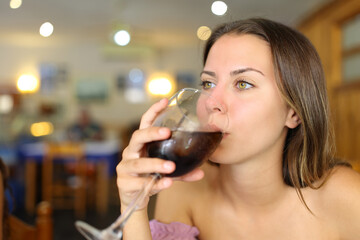Woman drinking soda refreshment in a restaurant