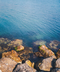 Obraz premium Seashore with large stones covered with moss. Beautiful nature abstract background. Shot from above