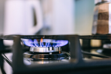 Fototapeta na wymiar Gas flames burning on kitchen stove top