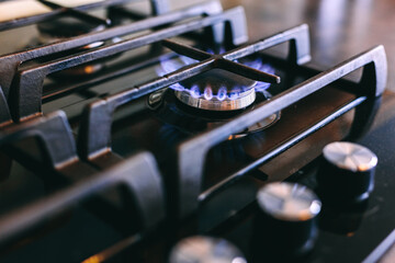 Gas flames burning on kitchen stove top