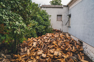 A stuck of chopped firewood in the courtyard of a country house. Preparing for winter