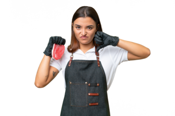 Butcher woman wearing an apron and serving fresh cut meat isolated on green chroma background showing thumb down with negative expression
