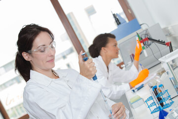 Laboratory worker using pipette