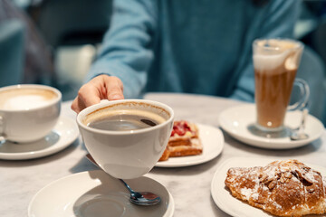 Woman is ready to drink morning coffee at a business breakfast