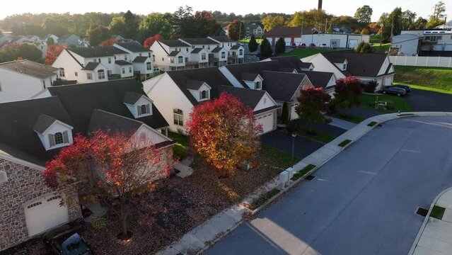 American homes in autumn. Aerial of colorful leaves and foliage among new duplex townhouses.