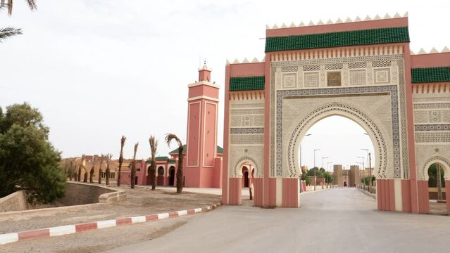 The entrance, city gate, bab, gate, door, leading into Rissani, South Morocco. Landmark and iconic touristic site of Rissani. 4k footage establishing shot.