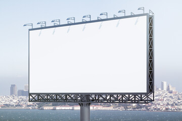 Blank white billboard on cityscape background at daytime, perspective view. Mock up, advertising...