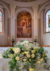 Wedding decorative bouquet of white roses on the altar of the church