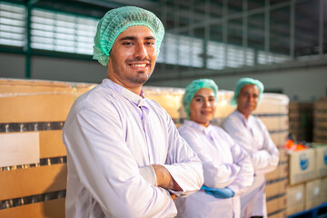 worker team on the production line in the beverage factory. Manufacturer checks quality of food industry. - 540637179