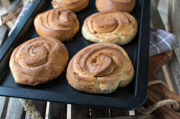 Homemade cinnamon rolls on a baking tray