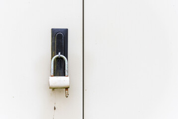 Old Rusty padlock with locked gray metal door texture background.Copy space.