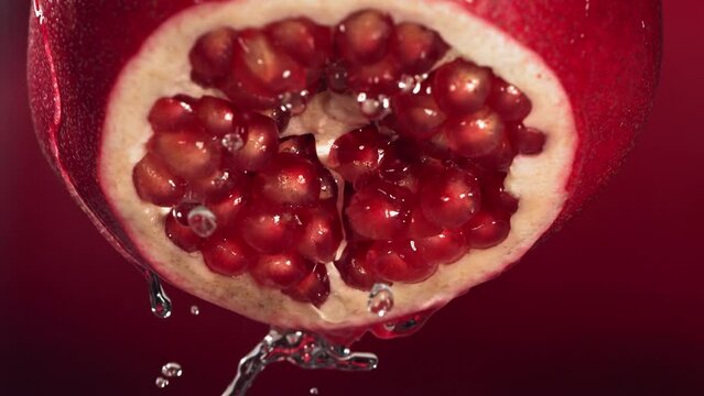 Slow Motion of Flowing Water from Half Pomegranate