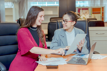 Fototapeta premium Finance,accounting,Businesswomen analyzing investment charts with calculator laptop calculate technology in office, marketing business analysis data concept