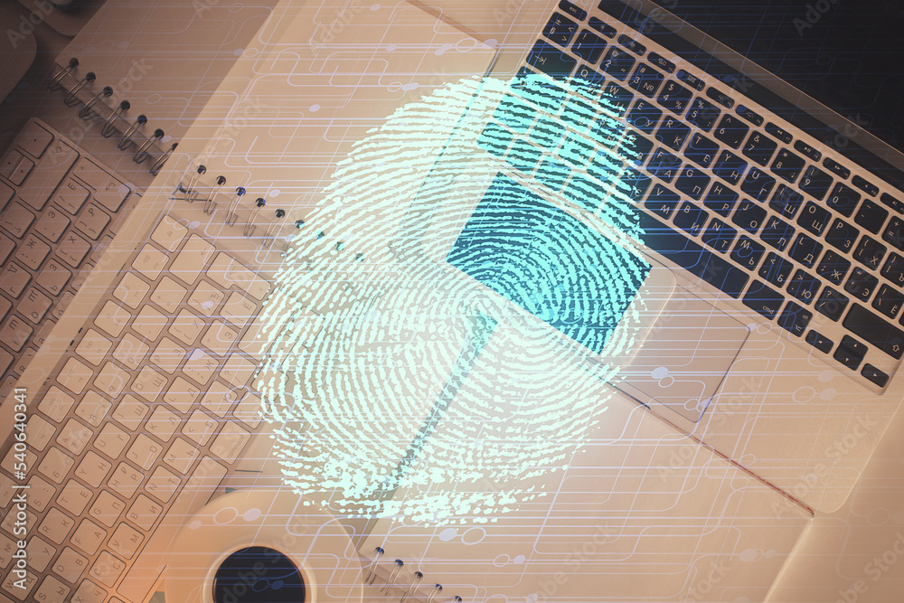 Poster Finger print over computer on the desktop background. Top view. Double exposure. Concept of securitization.