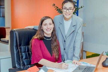 Finance,accounting,Businesswomen analyzing investment charts with calculator laptop calculate technology in office, marketing business analysis data concept