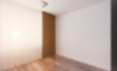Front view of an office interior with a row of dark wood tables.. Abstract blur phototography.
