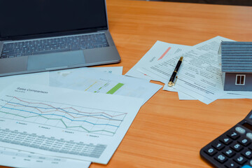 Business computer office desk with desktop laptop,notebook,clock,pen and annual reports,summary report,document and paper,working space at home.Business executive office table concept..