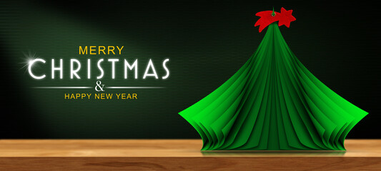 3D illustration of a green Christmas tree, made of curled up paper pages with red comet star on the top, on a wooden table with copy space and text Merry Christmas and Happy New Year. © Alberto Masnovo