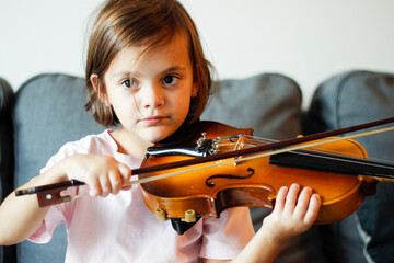 little girl learning to play the violin

