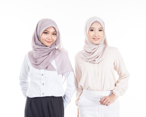 Portrait of two Muslim woman in office attire and wearing a hijab. Asian woman in a corporate world. Formal and elegant corporate outfit. Corporate or business people concept. Isolated