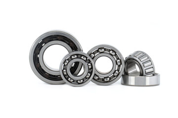 Group of various ball and roller bearings on white