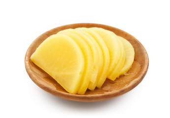 Korean yellow pickled radish or Danmuji side dish in wood bowl isolated on white background. yellow...