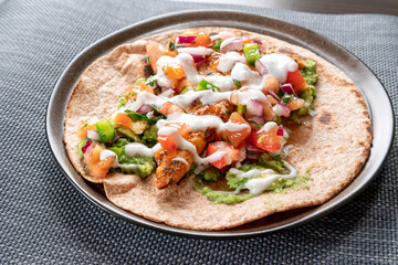 taco with chicken and tomatoes salsa