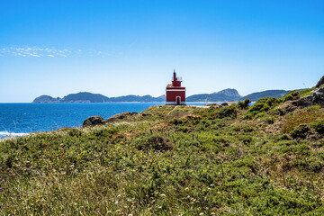 Fototapeta na wymiar Red lighthouse in Punta Robaleira, Costa da Vela, Pontevedra, Galicia, Spain
