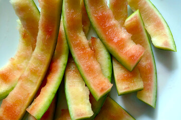 Skins from eaten watermelon, leftover food. Fruit background.