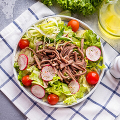 Salad with boiled beef tongue and vegetables. Top view