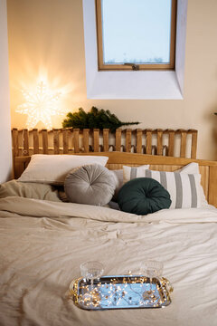 Christmas tree in the bedroom with a bed , Christmas holiday gifts garland