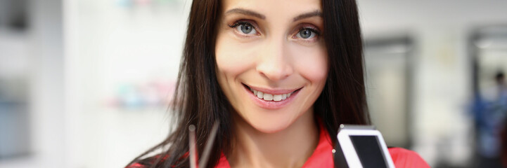 Obraz premium Young pretty master hold tools for work, shaving machine and scissors