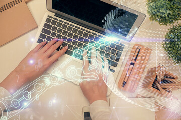 Double exposure of woman hands working on computer and tech theme hologram drawing. Top View. Technology concept.